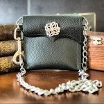 Black Leather Celtic Waist Wallet PouchThis rich black leather envelope style wallet features white contrast stitching and a cupid's bow asymmetrical flap, adorned with an Irish Celtic knot accent and functional magnetic snap closure. Please note that all leather will vary slightly in colour, texture and patina – making each order truly one-of-a-kind.
